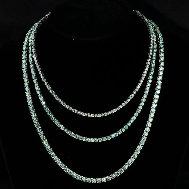 Elegant tennis chain adorned with exquisite blue green gemstones, a perfect luxury accessory for refined style.