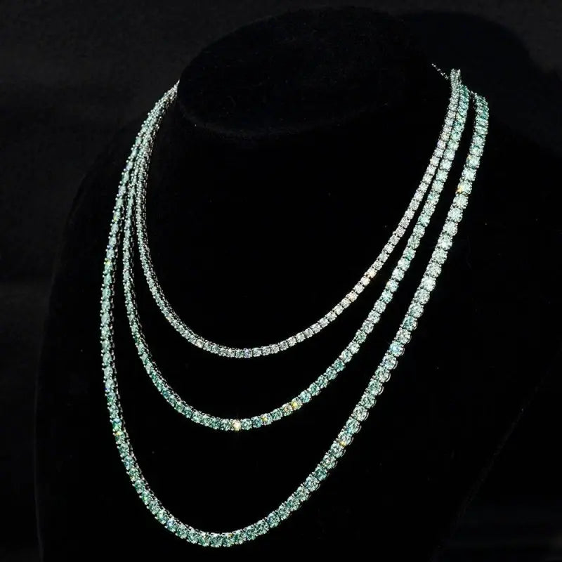 Elegant tennis chain adorned with exquisite blue green gemstones, a perfect luxury accessory for refined style.
