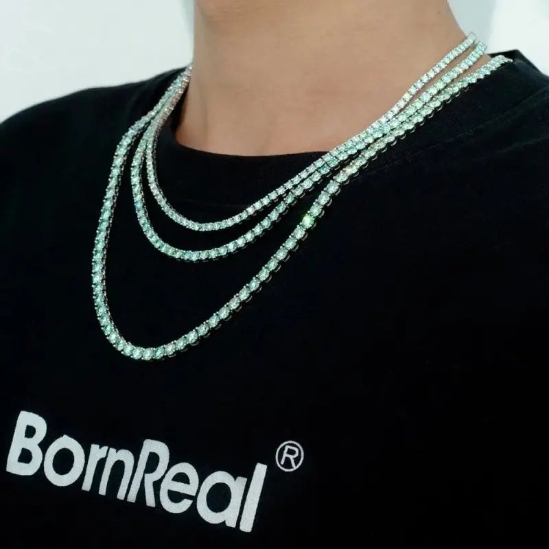 Elegant tennis chain adorned with exquisite blue green gemstones, a perfect luxury accessory for refined style.