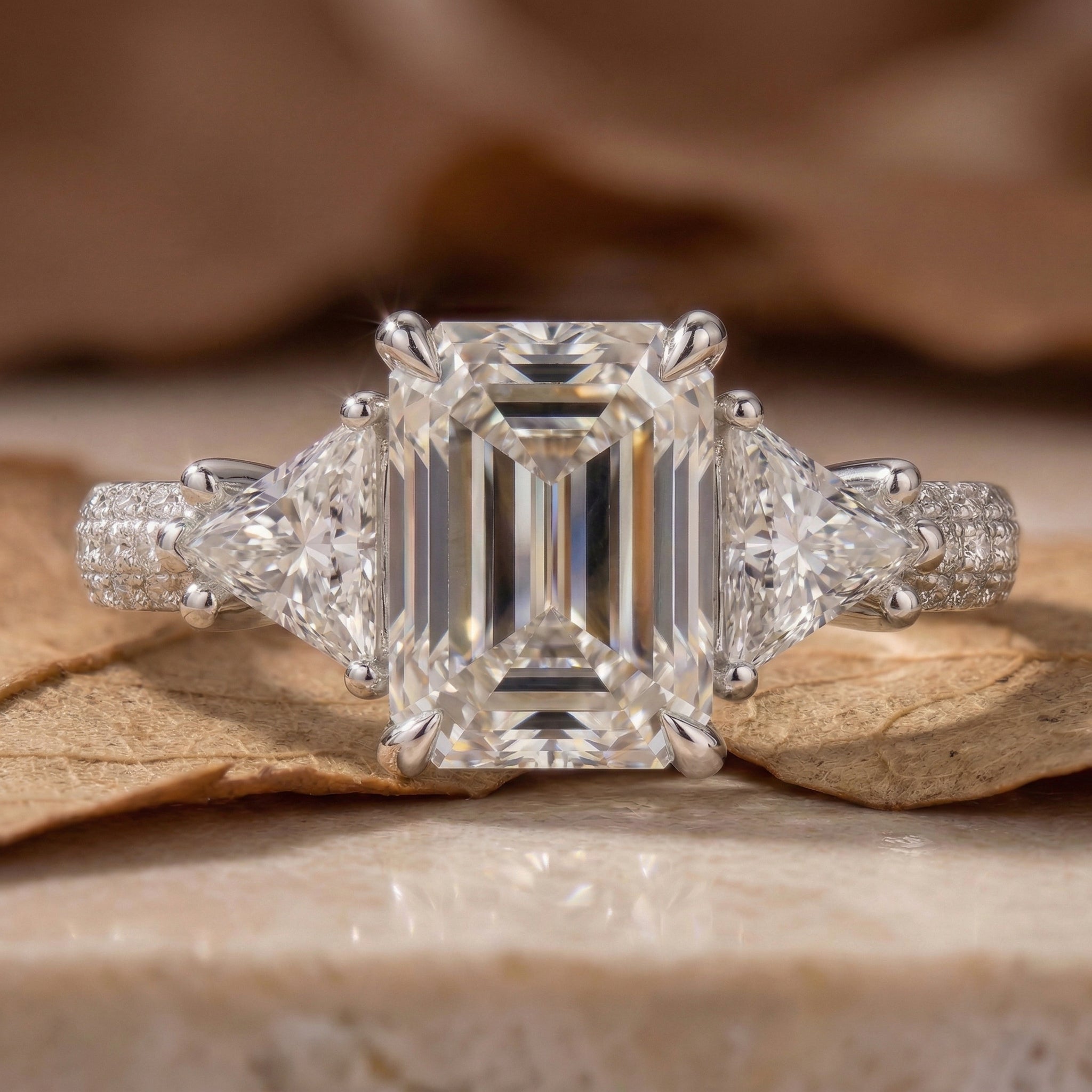 R0824 Emerald Cut Trilogy Ring with Trillion Side Stones